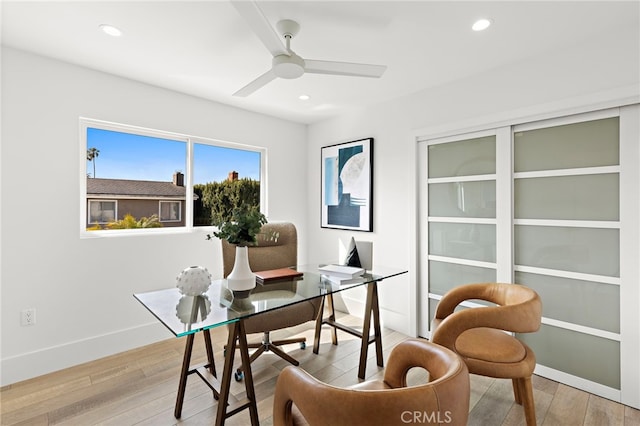 office space featuring recessed lighting, light wood-style flooring, a ceiling fan, and baseboards