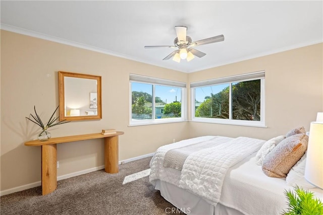 carpeted bedroom featuring crown molding, baseboards, and ceiling fan