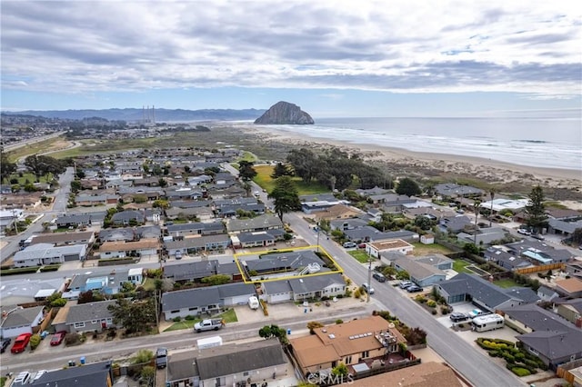 bird's eye view with a residential view, a water view, and a view of the beach