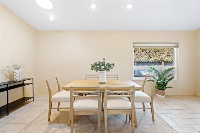 dining area featuring stone tile flooring, recessed lighting, and baseboards