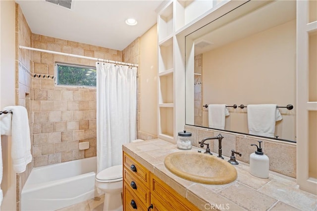 full bath with visible vents, vanity, toilet, and shower / bath combo with shower curtain