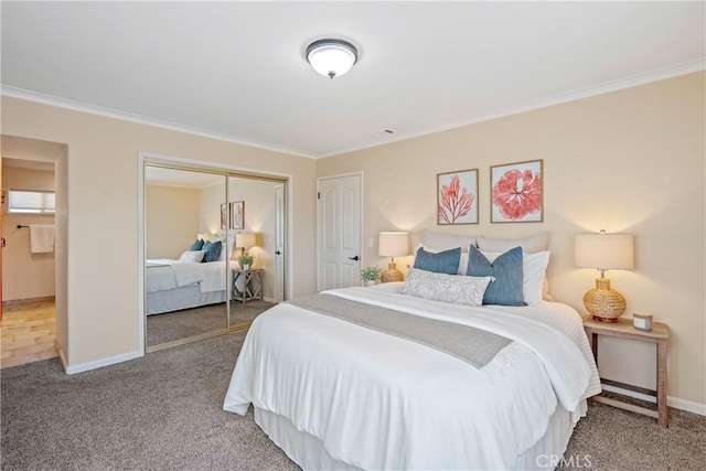 bedroom with a closet, carpet floors, and ornamental molding