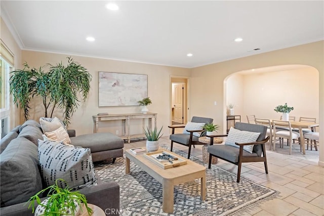 living room featuring crown molding, recessed lighting, and arched walkways