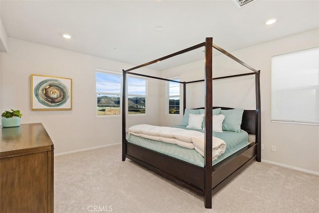 bedroom with recessed lighting, light colored carpet, and baseboards