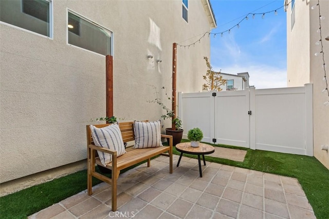 view of patio with a gate and fence