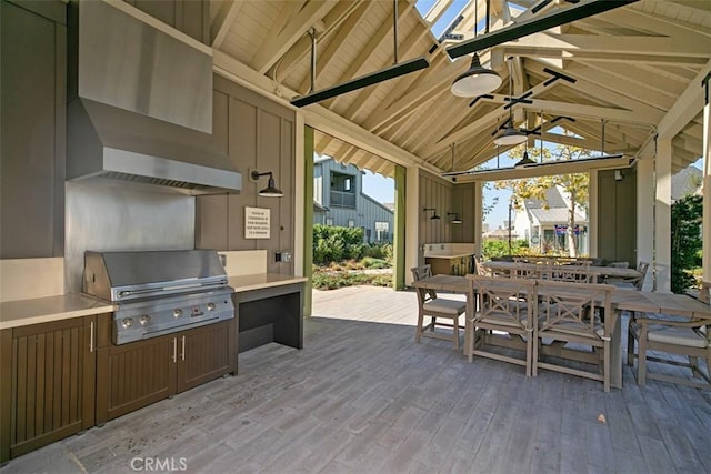 exterior space with outdoor dining area, area for grilling, and ceiling fan