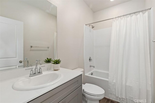 full bath featuring vanity, toilet, and shower / tub combo