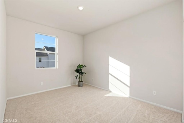 carpeted empty room featuring recessed lighting and baseboards