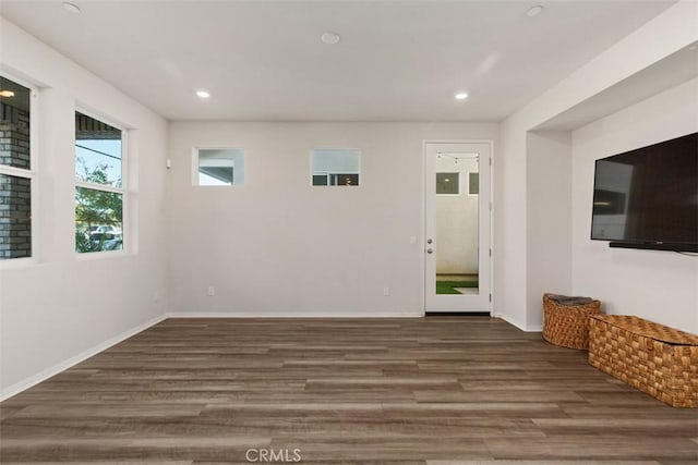 empty room featuring recessed lighting, baseboards, and wood finished floors