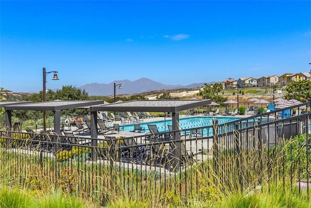 pool featuring a patio and a mountain view