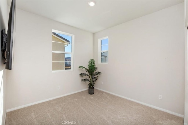 unfurnished room with baseboards and carpet floors