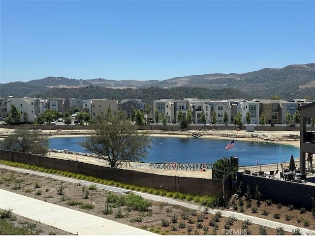 property view of water featuring a mountain view and a residential view