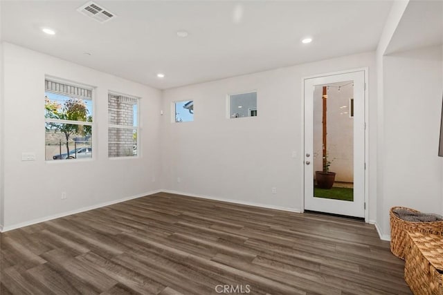 spare room featuring recessed lighting, visible vents, baseboards, and wood finished floors