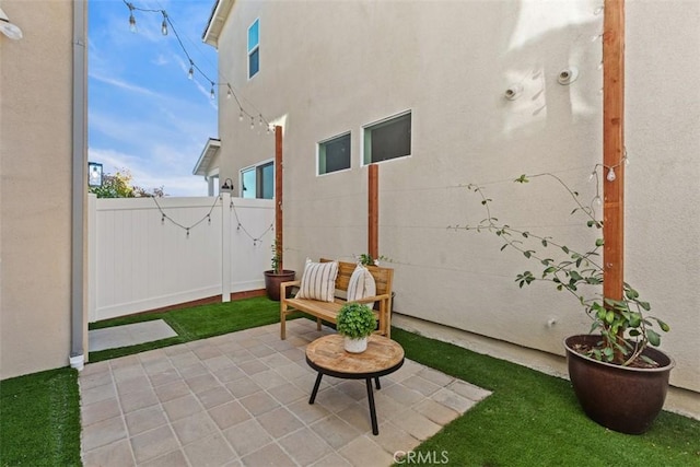 view of patio featuring fence