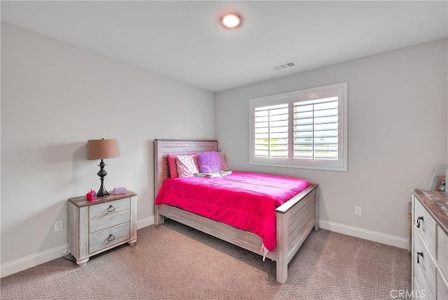 carpeted bedroom featuring baseboards and visible vents