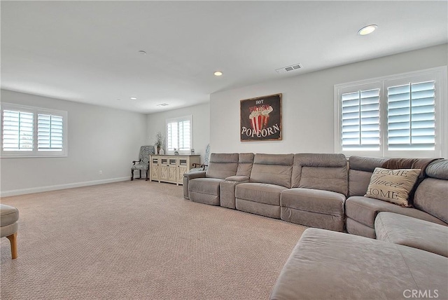 living room featuring recessed lighting, visible vents, baseboards, and light colored carpet