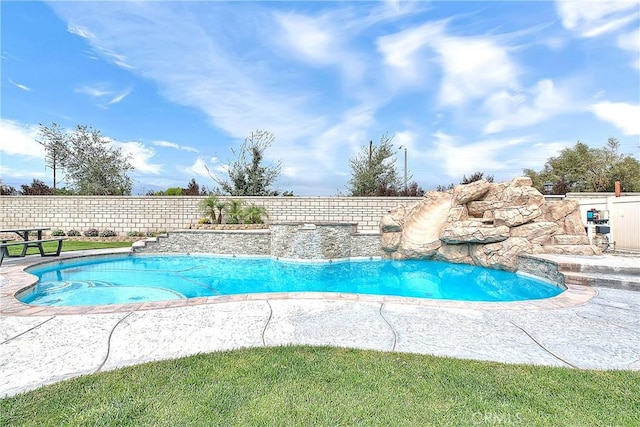 view of swimming pool with a fenced in pool, a water slide, and fence