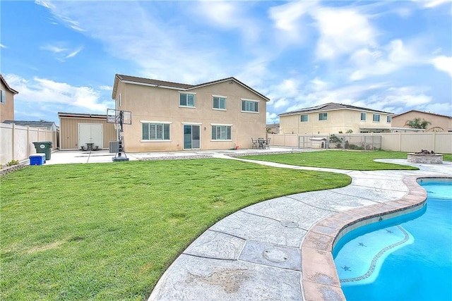 rear view of house with a patio, a fenced backyard, a yard, a fenced in pool, and central AC unit