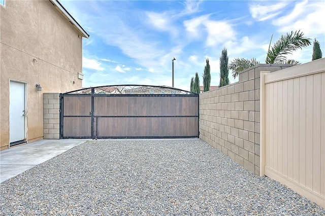 view of gate with fence