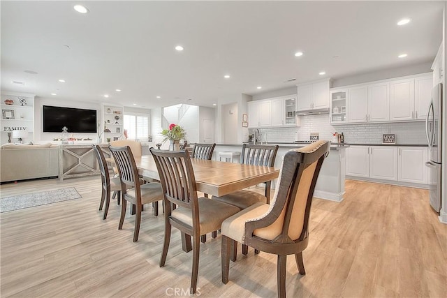 dining room with recessed lighting and light wood finished floors