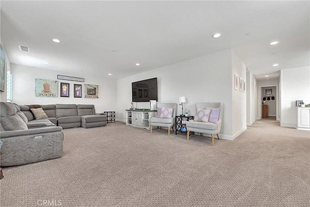 living area with recessed lighting, light colored carpet, and baseboards