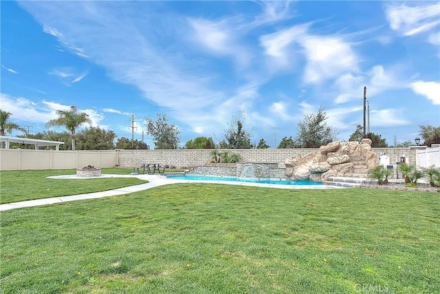 view of yard featuring a fenced in pool, an outdoor fire pit, and a fenced backyard