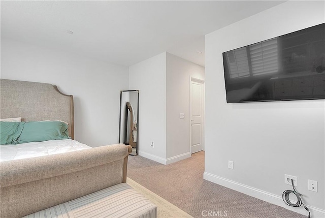 carpeted bedroom with baseboards