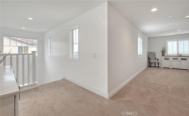 hall with recessed lighting, baseboards, and light carpet