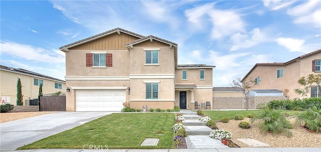 traditional-style house with stucco siding, fence, concrete driveway, a front yard, and a garage