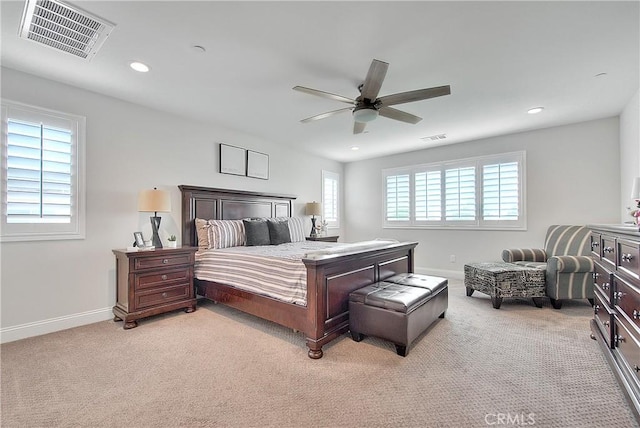 bedroom featuring light colored carpet, visible vents, and baseboards