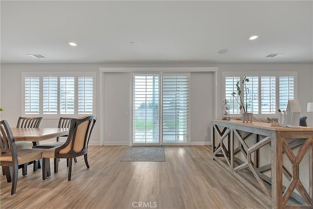 dining room with recessed lighting, visible vents, a wealth of natural light, and light wood-type flooring