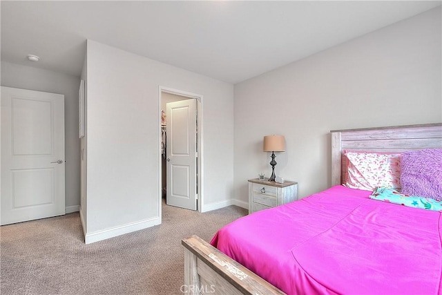 carpeted bedroom featuring baseboards