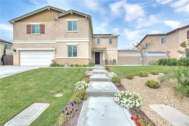 traditional-style house featuring stucco siding, driveway, a front yard, and fence