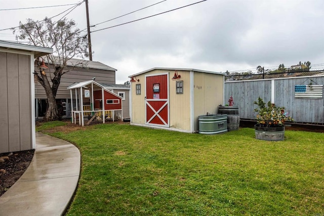 view of shed featuring fence