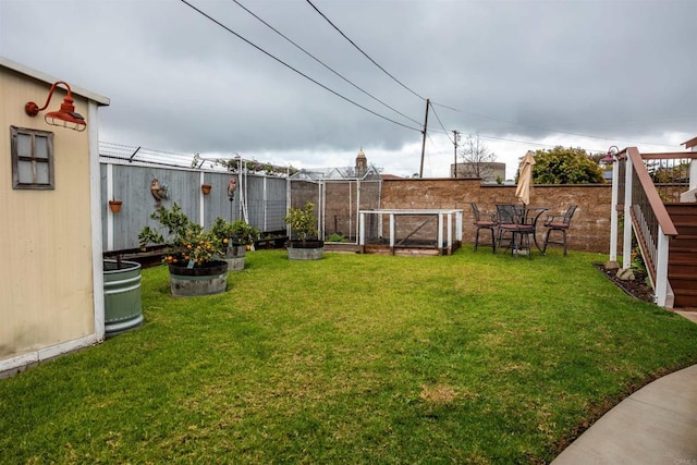 view of yard with a vegetable garden and fence