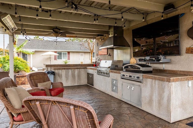 view of patio / terrace featuring area for grilling, a ceiling fan, and grilling area