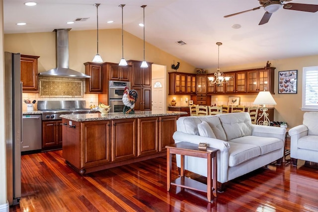 kitchen featuring visible vents, ceiling fan with notable chandelier, appliances with stainless steel finishes, and wall chimney exhaust hood