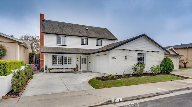 view of front of home with a garage, brick siding, concrete driveway, and a shingled roof