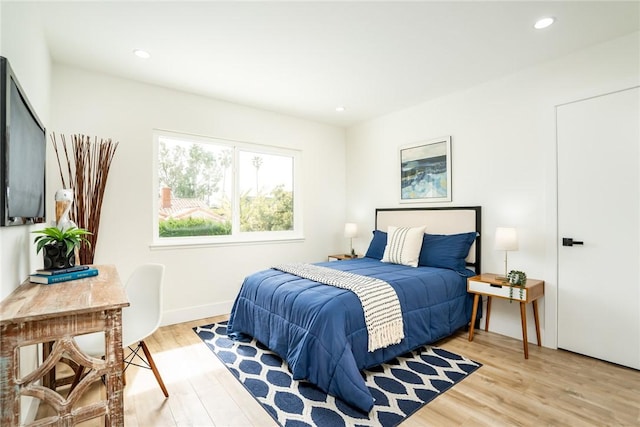 bedroom featuring recessed lighting, light wood-style flooring, and baseboards