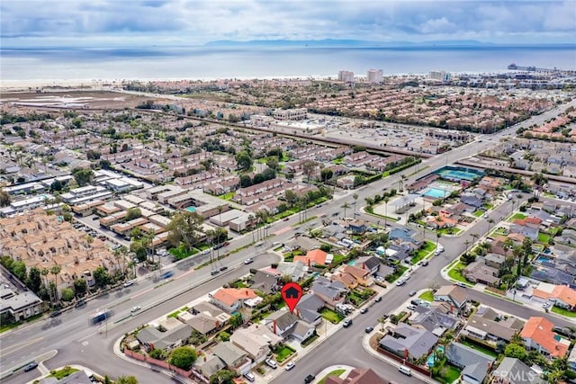 drone / aerial view with a residential view and a water view