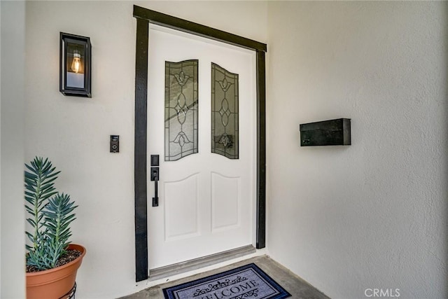 property entrance featuring stucco siding