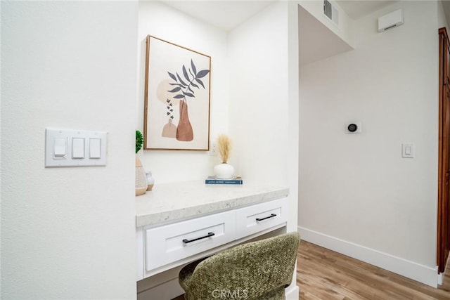 room details featuring baseboards and wood finished floors