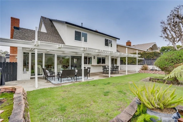 rear view of property with fence, a pergola, a shingled roof, a patio area, and a lawn