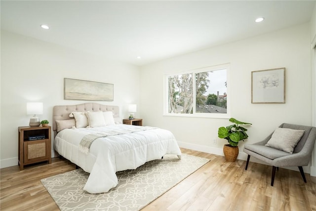 bedroom with recessed lighting, baseboards, and light wood-style flooring