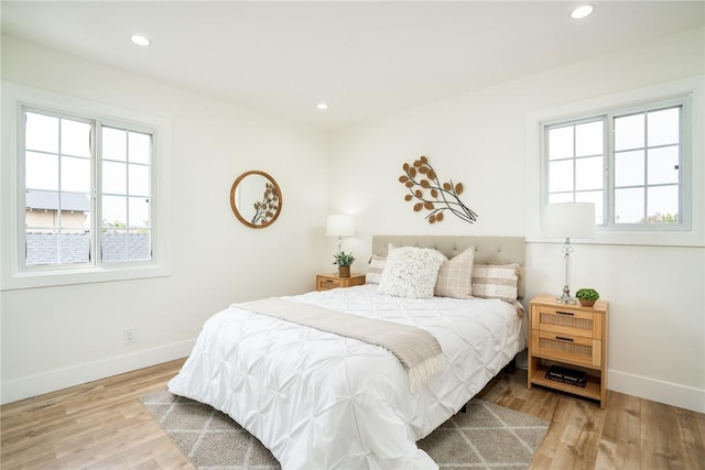 bedroom featuring recessed lighting, wood finished floors, and baseboards