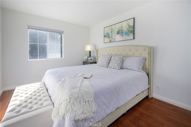 bedroom featuring wood finished floors and baseboards