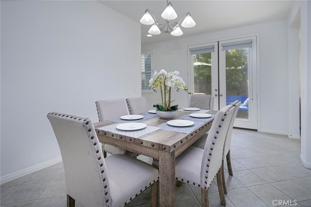 dining area featuring french doors, baseboards, a chandelier, and light tile patterned flooring