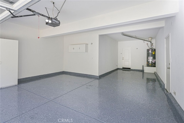 garage featuring secured water heater, a garage door opener, and baseboards