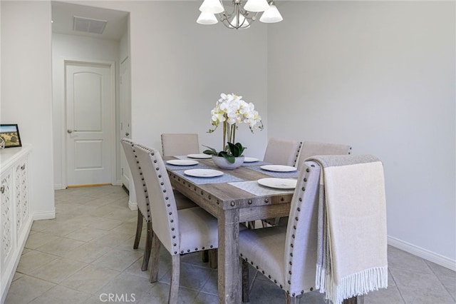 dining area with a chandelier, visible vents, baseboards, and light tile patterned floors