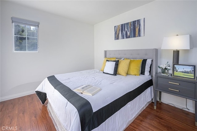 bedroom featuring baseboards and wood finished floors